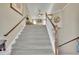 Carpeted staircase leading to a bright upper level, featuring wood handrails and neutral walls at 3222 Pagoda Trce, Lawrenceville, GA 30043