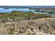 Stunning aerial view showcases the lakefront neighborhood, offering serene lakeside living and natural beauty at 7025 Bavarian Wood Pl, Buford, GA 30518