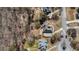 Aerial view of a beautiful home on a meticulously landscaped lot surrounded by mature trees at 7025 Bavarian Wood Pl, Buford, GA 30518