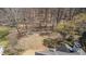 Aerial view of the private backyard that backs up to a wooded lot with mature trees at 7025 Bavarian Wood Pl, Buford, GA 30518