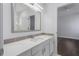Bathroom featuring a large mirror, granite countertops, and white cabinets at 7025 Bavarian Wood Pl, Buford, GA 30518