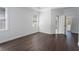 Well-lit bedroom featuring hardwood floors, two large windows, and a neutral color scheme at 7025 Bavarian Wood Pl, Buford, GA 30518