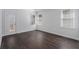 Bright and airy bedroom with hardwood floors, tray ceilings, and a door leading to a private deck at 7025 Bavarian Wood Pl, Buford, GA 30518