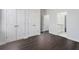 Bedroom with hardwood floors, walk-in closets, leading to a bathroom featuring granite countertops at 7025 Bavarian Wood Pl, Buford, GA 30518