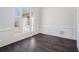 Dining room with hardwood floors, decorative wall paneling, and a large window at 7025 Bavarian Wood Pl, Buford, GA 30518