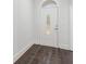 Bright entryway featuring a classic white door with decorative glass insert and dark wood flooring at 7025 Bavarian Wood Pl, Buford, GA 30518
