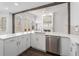 Modern kitchen boasting a large island, stainless steel appliances, and a fireplace with a decorative mirror above at 7025 Bavarian Wood Pl, Buford, GA 30518