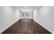 Spacious living room featuring dark hardwood floors, a bay window offering natural light, and freshly painted white walls at 7025 Bavarian Wood Pl, Buford, GA 30518