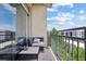 Cozy balcony with outdoor seating and views of the surrounding trees and buildings at 711 Cosmopolitan Ne Dr # 523, Atlanta, GA 30324
