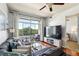 Comfortable living room featuring hardwood floors, balcony access, and a modern entertainment center at 711 Cosmopolitan Ne Dr # 523, Atlanta, GA 30324