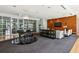 Elegant lounge area with grand piano, sleek furniture, and a decorative wood-paneled wall at 711 Cosmopolitan Ne Dr # 523, Atlanta, GA 30324