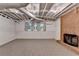 Finished basement space with a brick fireplace, windows, and carpet providing a cozy and functional area at 10835 Tuxford Dr, Alpharetta, GA 30022