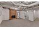 Spacious carpeted basement featuring a brick fireplace, windows, and easy outside access at 10835 Tuxford Dr, Alpharetta, GA 30022