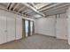 Carpeted basement area featuring two windows and a storage closet with easy outside access at 10835 Tuxford Dr, Alpharetta, GA 30022