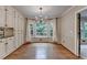 Charming dining area with hardwood floors, built-in cabinets, and a bay window overlooking the backyard at 10835 Tuxford Dr, Alpharetta, GA 30022