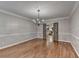 Bright dining room with hardwood floors, chair rail, and modern light fixture at 10835 Tuxford Dr, Alpharetta, GA 30022