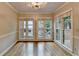 Dining Room with hardwood floors, neutral paint, crown molding, base boards and windows at 10835 Tuxford Dr, Alpharetta, GA 30022