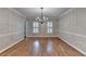 Spacious dining room featuring hardwood floors, a modern chandelier, and ample natural light at 10835 Tuxford Dr, Alpharetta, GA 30022