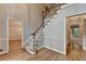 Elegant foyer featuring hardwood floors, a staircase with a white banister, and neutral wall color at 10835 Tuxford Dr, Alpharetta, GA 30022