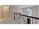 Inviting foyer featuring staircase, pendant lighting, and an arched window, leading to the main floor at 10835 Tuxford Dr, Alpharetta, GA 30022