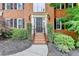 Charming brick home with a welcoming front entrance, complemented by manicured landscaping and stylish accents at 10835 Tuxford Dr, Alpharetta, GA 30022