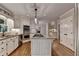 Updated kitchen boasts stainless appliances, granite countertops, a center island with cooktop and hardwood floors at 10835 Tuxford Dr, Alpharetta, GA 30022