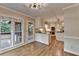 Eat in kitchen features stainless appliances, granite countertops, island with cooktop and access to screened porch at 10835 Tuxford Dr, Alpharetta, GA 30022