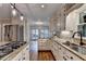Updated kitchen features stainless appliances, granite countertops and center island with built in cooktop at 10835 Tuxford Dr, Alpharetta, GA 30022