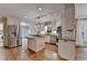 Updated kitchen features stainless appliances, granite countertops, a center island with cooktop, and hardwood floors at 10835 Tuxford Dr, Alpharetta, GA 30022