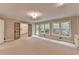 Open-concept room offering generous space, natural light, neutral tones, and a glimpse into the kitchen at 10835 Tuxford Dr, Alpharetta, GA 30022