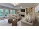 Bright living room with fireplace, built-in shelving and neutral decor at 10835 Tuxford Dr, Alpharetta, GA 30022