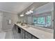 Luxurious main bathroom featuring double sinks, large mirrors, a soaking tub, and abundant natural light at 10835 Tuxford Dr, Alpharetta, GA 30022