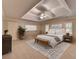 Bedroom featuring tray ceiling, neutral tones, and ample natural light at 10835 Tuxford Dr, Alpharetta, GA 30022