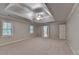 Spacious primary bedroom with tray ceiling, fan, and plush carpeting for a relaxing retreat at 10835 Tuxford Dr, Alpharetta, GA 30022