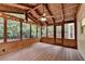 Enclosed porch with wood ceiling, wooden floors, lots of windows and a ceiling fan at 10835 Tuxford Dr, Alpharetta, GA 30022