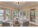 Bright sitting area with multiple windows and neutral seating at 10835 Tuxford Dr, Alpharetta, GA 30022