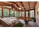 Cozy sun room with wood ceiling, ceiling fan and views of mature trees at 10835 Tuxford Dr, Alpharetta, GA 30022