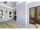 Light gray home featuring a wooden deck with french doors and windows along the side at 585 Sherwood Ne Rd, Atlanta, GA 30324