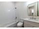 Bright bathroom featuring white subway tile, modern fixtures, and a sleek vanity with undermount sink at 585 Sherwood Ne Rd, Atlanta, GA 30324
