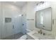 Modern bathroom with glass-enclosed shower, white tile, and marble vanity, exuding a spa-like ambiance at 585 Sherwood Ne Rd, Atlanta, GA 30324