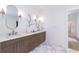 This bathroom features double sinks, stylish fixtures, and hexagonal floor tiles at 585 Sherwood Ne Rd, Atlanta, GA 30324