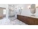 A bright bathroom features a glass shower, a double vanity with marble countertop, and stylish gray tile floors at 585 Sherwood Ne Rd, Atlanta, GA 30324