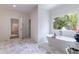 The bathroom offers a relaxing tub near the window and stylish hexagonal floor tiles at 585 Sherwood Ne Rd, Atlanta, GA 30324