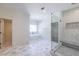 Bright bathroom showcasing a modern freestanding tub and an adjacent glass shower, with stylish gray tiled flooring at 585 Sherwood Ne Rd, Atlanta, GA 30324
