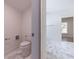 Bathroom featuring a toilet, and hexagonal floor tiles with an entrance to another room at 585 Sherwood Ne Rd, Atlanta, GA 30324