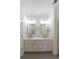 Modern bathroom featuring double vanity with white marble countertop and gray tile floors at 585 Sherwood Ne Rd, Atlanta, GA 30324