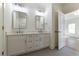 Modern bathroom featuring double vanity with white marble countertop and gray tile floors at 585 Sherwood Ne Rd, Atlanta, GA 30324