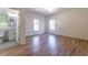 Bright bedroom with hardwood floors and two windows, adjacent to a full bathroom at 585 Sherwood Ne Rd, Atlanta, GA 30324