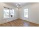Well-lit bedroom with hardwood floors, large windows, and stylish ceiling lighting at 585 Sherwood Ne Rd, Atlanta, GA 30324