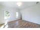 Well-lit bedroom with hardwood floors, windows, and white walls at 585 Sherwood Ne Rd, Atlanta, GA 30324